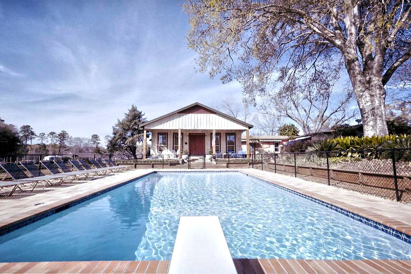Cabin rental with private hot tub and access to shared pool in Kennard, Texas.