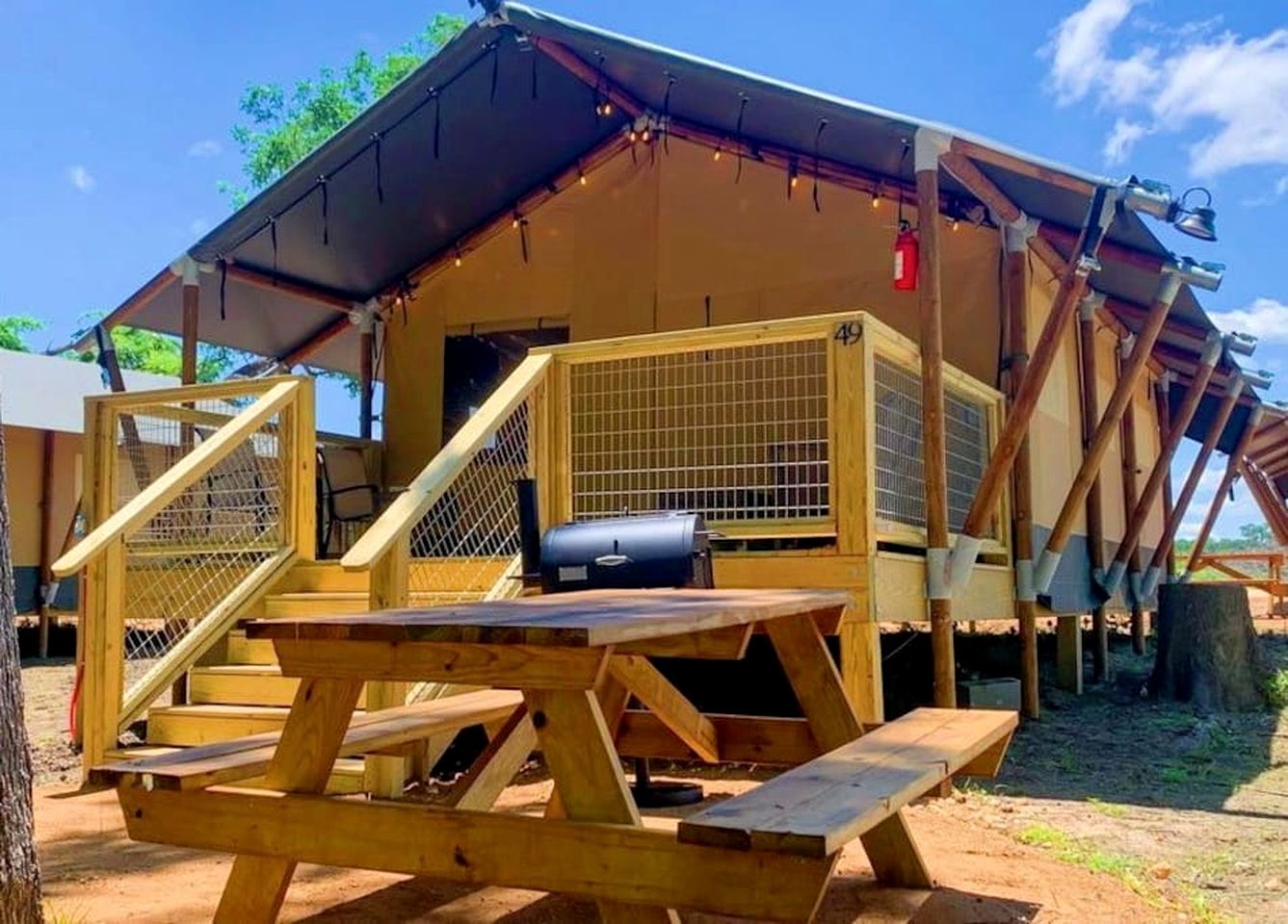Deluxe Safari Tent Cabin with Creek Swimming, Fishing & Resort-Style Amenities in Marion, Texas