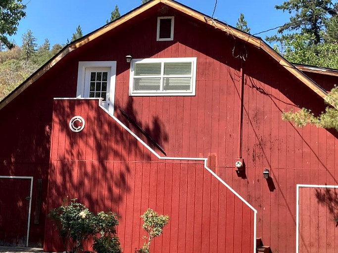 Farm stay in a red barn for a rural glamping experience.