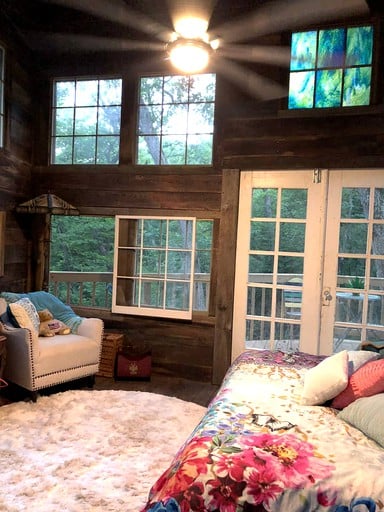 Cozy bedroom of tree house cabins in MO