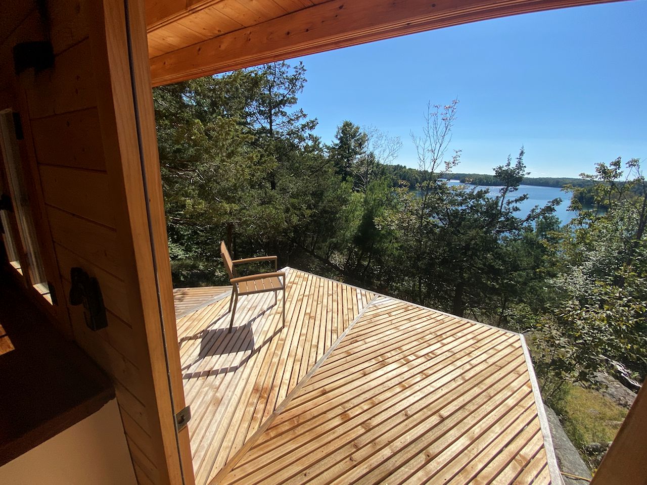 Cozy Off-Grid Cabin Surrounded by Trees with an Incredible View of Buck Lake in Perth Road, Ontario