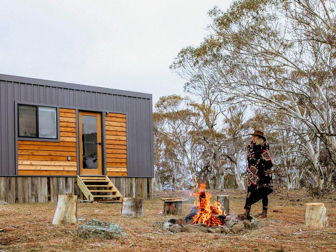 The gorgeous tiny house in New South Wales with a fire blazing merrily away in the fire pit