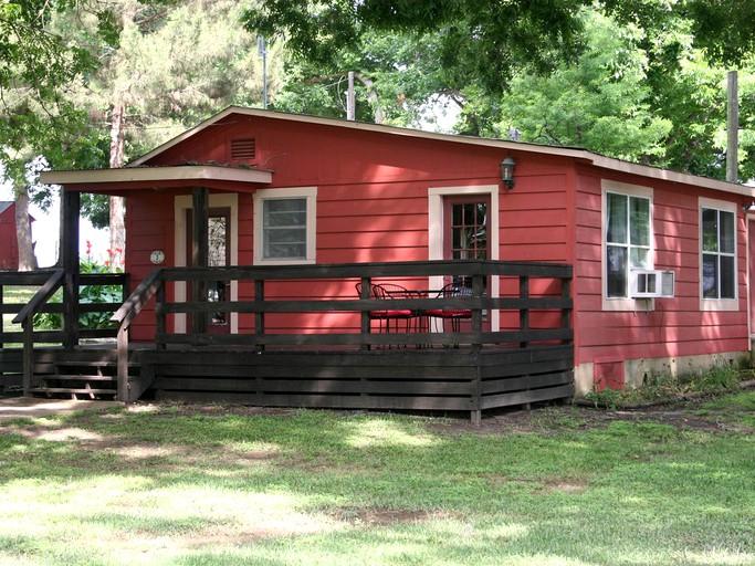 Red cabin rental on Lake Dunlap in Texas.