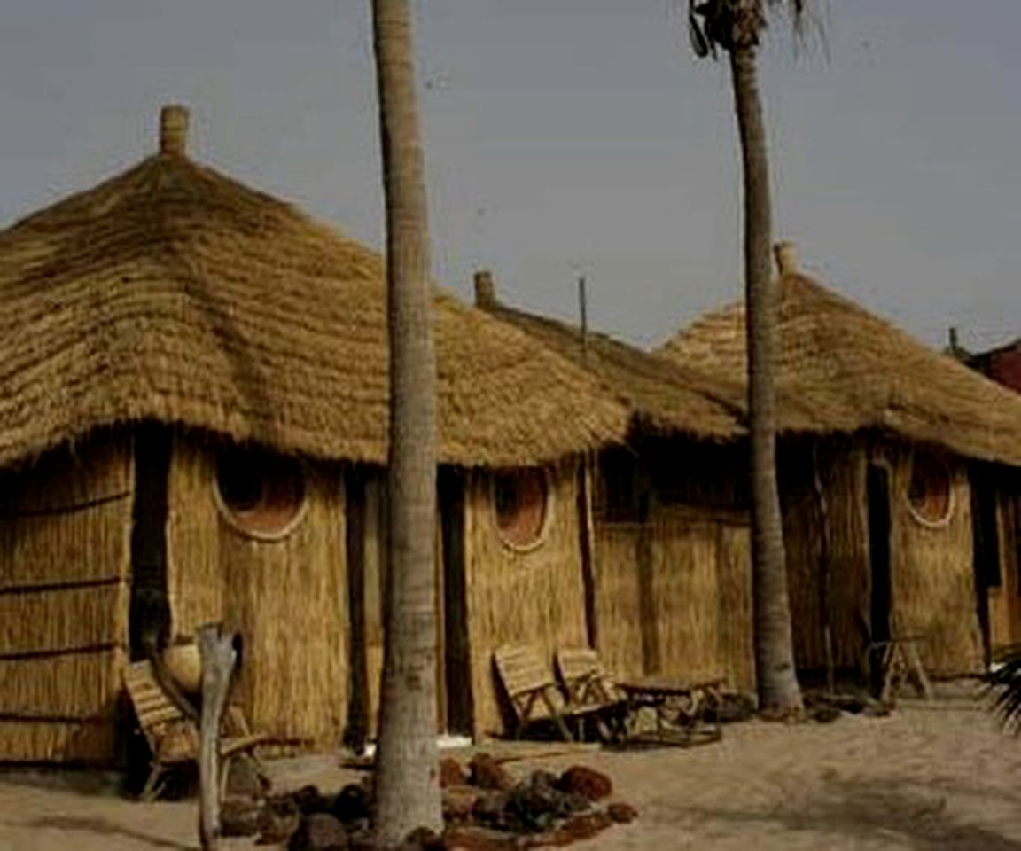 Elegant Beachside Huts near a Vibrant Port Town in Senegal, Africa