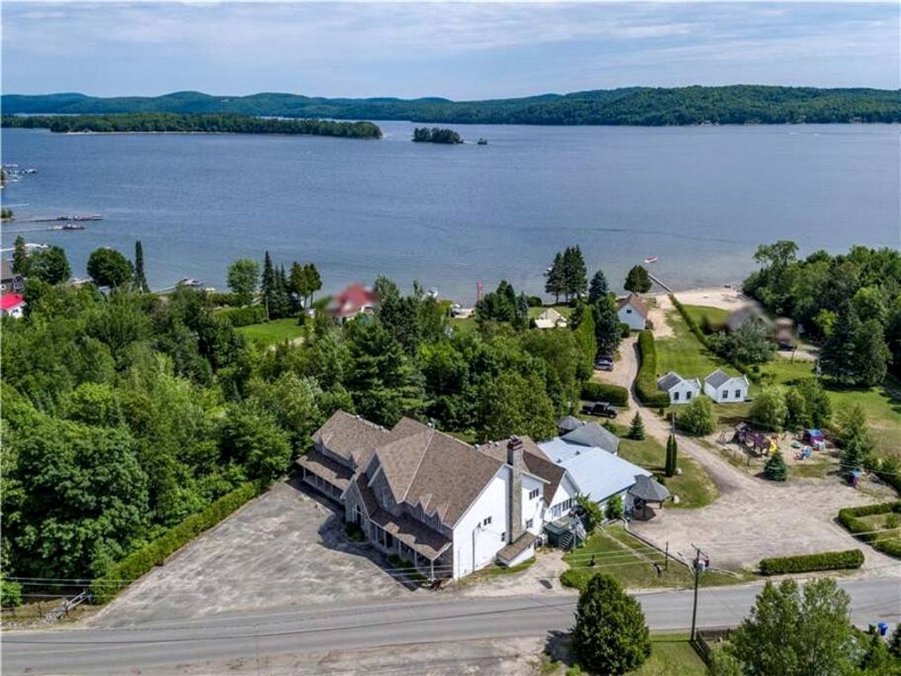 Enormous Lakefront Villa with Interior Pool, Game Room and Gym Space in Lac des Plages, Quebec