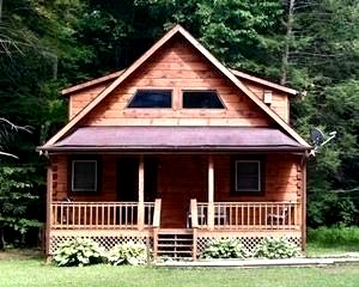 Rustic Wooden Cabin Settled Between Trees in Monterville, West Virginia