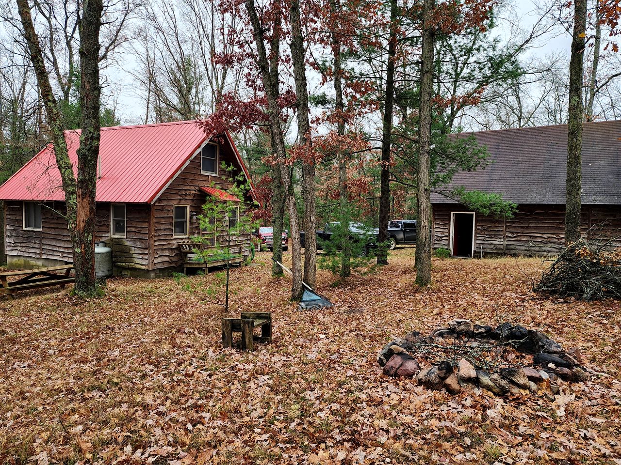 Secluded Luxury Cabin with Hot Tub on 10 Private Acres near Trails in Reed City, Michigan