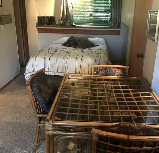 Double bed and small table with chairs in a suite of a bed and breakfast near Seattle, Washington.