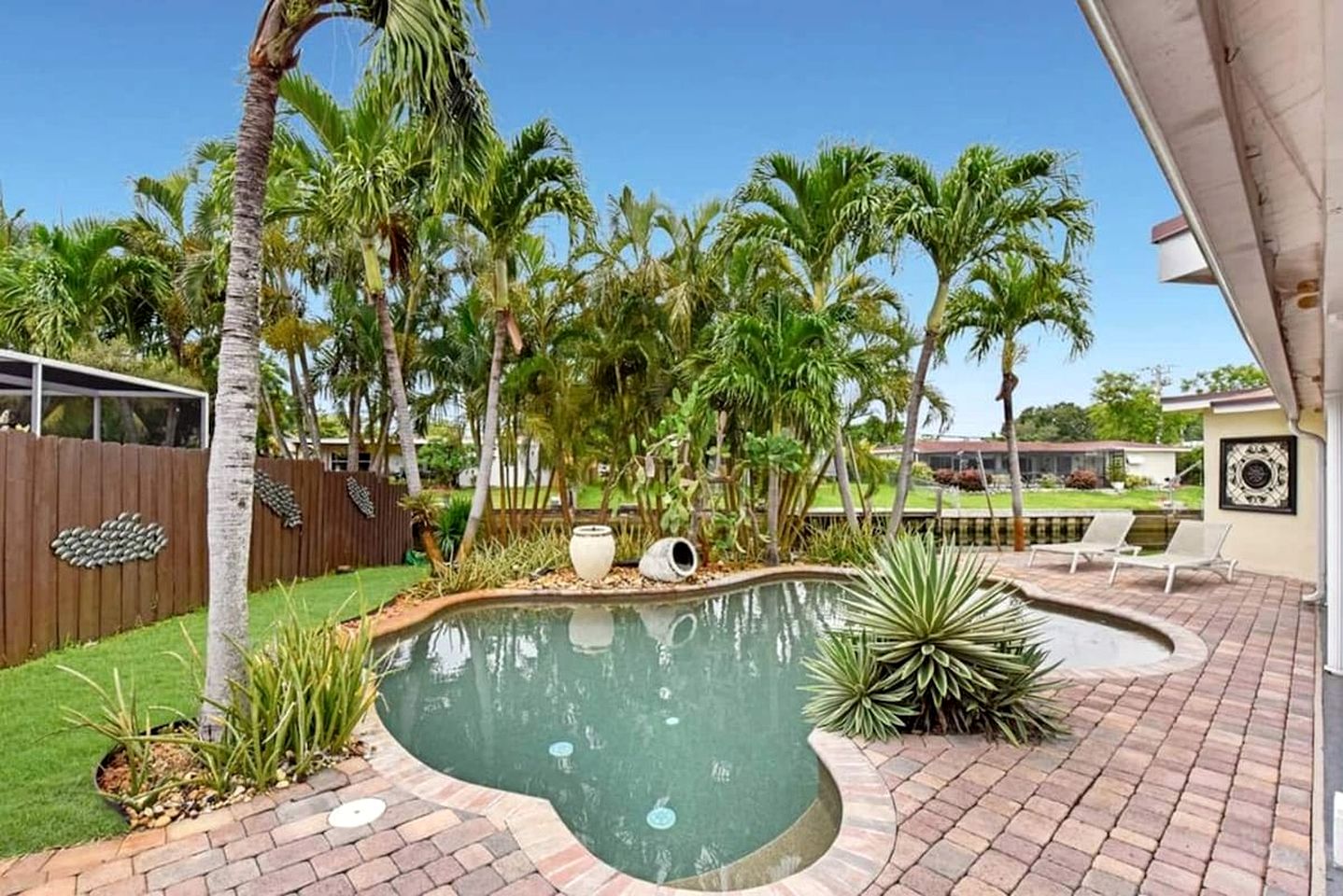 Modern Waterfront Home with Pool, Tesla EV Charger & Canal Fishing near Lauderdale-by-the-Sea Beach, Oakland Park Florida