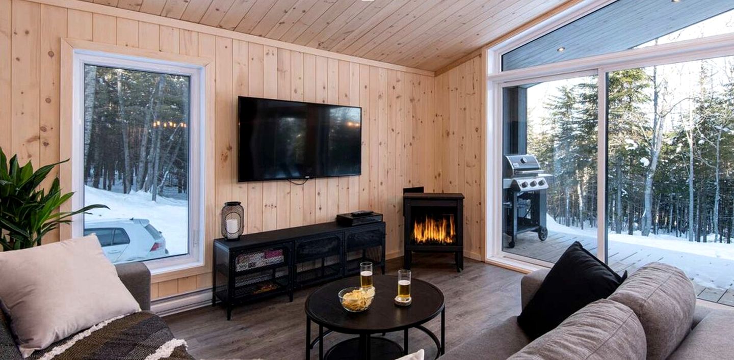 Secluded Forest Retreat with Stylish Interior in Domaine Charlevoix, Quebec