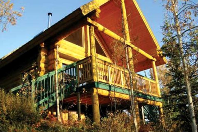 Log cabin rental with front deck in Whitehorse, Canada.