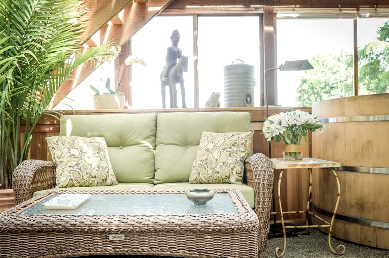 Living room with wicker furniture in cottage rental perfect for couples near Portland, Oregon.