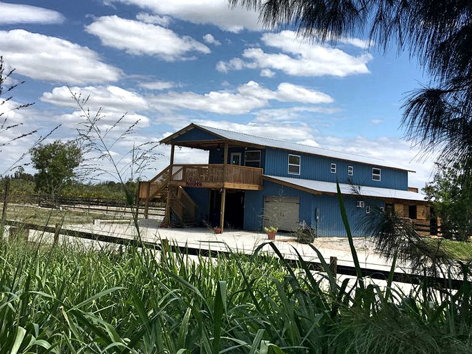 Exterior of Pine Island cottage under cloudy, blue skies