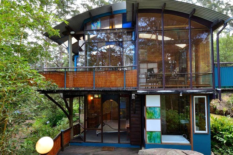 Treehouse homes in Denmark with large windows overlooking the greenery