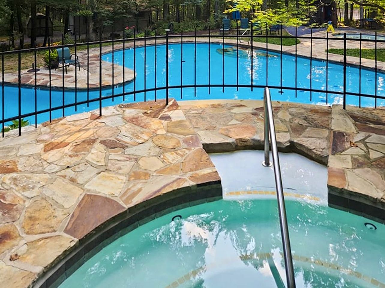 Spacious Cabin Retreat with Hot Tub, Fire Pit, Large Deck and Access to Community Pool and Other Amenities at this Berekely Springs, WV Getaway