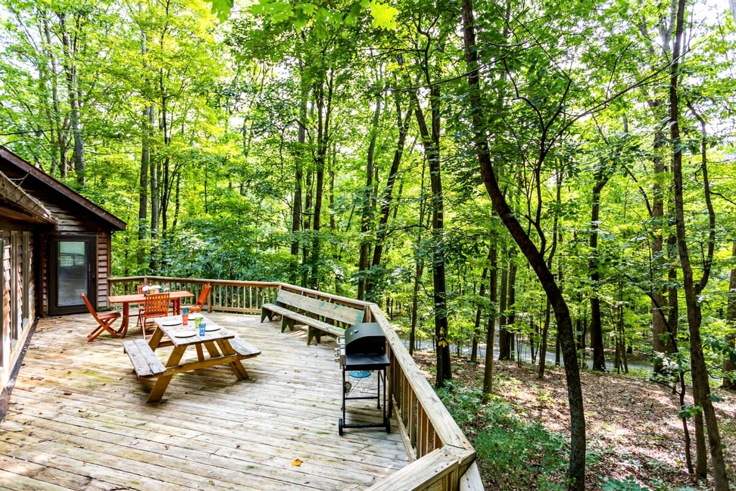 Spacious Cabin Retreat with Hot Tub, Fire Pit, Large Deck and Access to Community Pool and Other Amenities at this Berekely Springs, WV Getaway