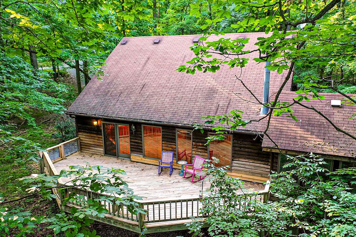 Spacious Cabin Retreat with Hot Tub, Fire Pit, Large Deck and Access to Community Pool and Other Amenities at this Berekely Springs, WV Getaway