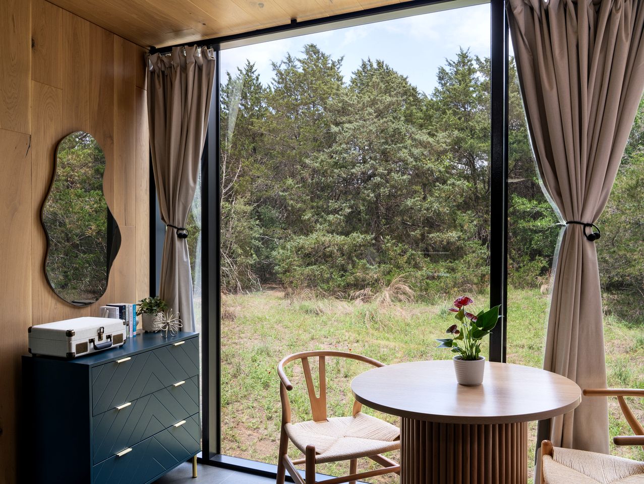 Whimsical Flower-Inspired Mirror Cabin by the Lake in the Enchanted Forests of Texas