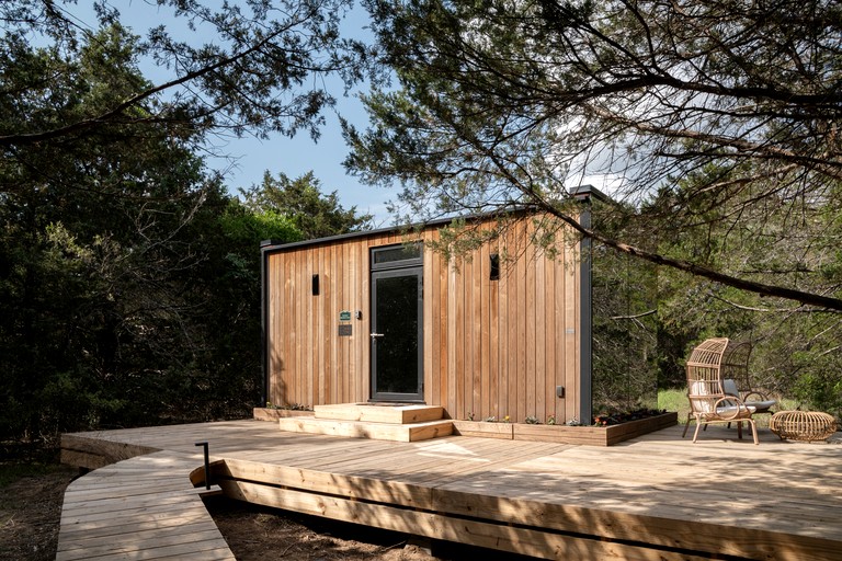 Whimsical Flower-Inspired Mirror Cabin by the Lake in the Enchanted Forests of Texas