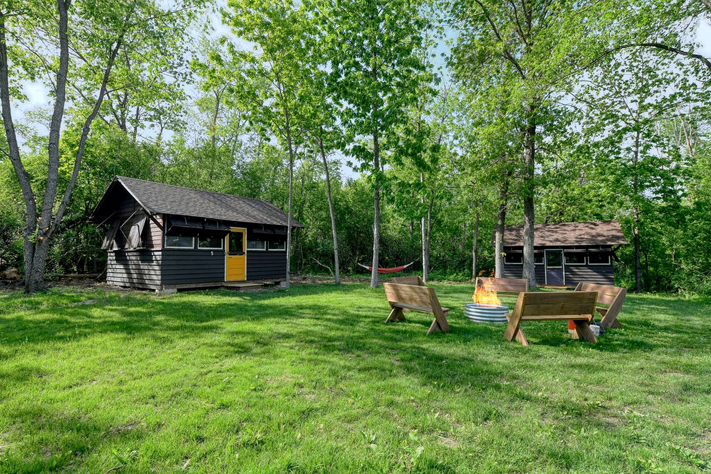 Three Cozy Historic Scout Cabins with Fire Pit, BBQ, and Hammocks for a Memorable Family Adventure in Troy, Wisconsin