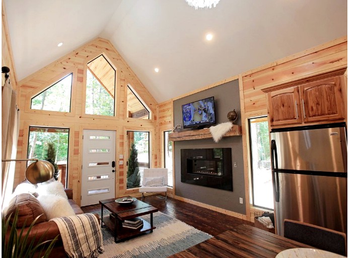 Living room with fireplace and sofa in a Beavers Bend resort park cabin.