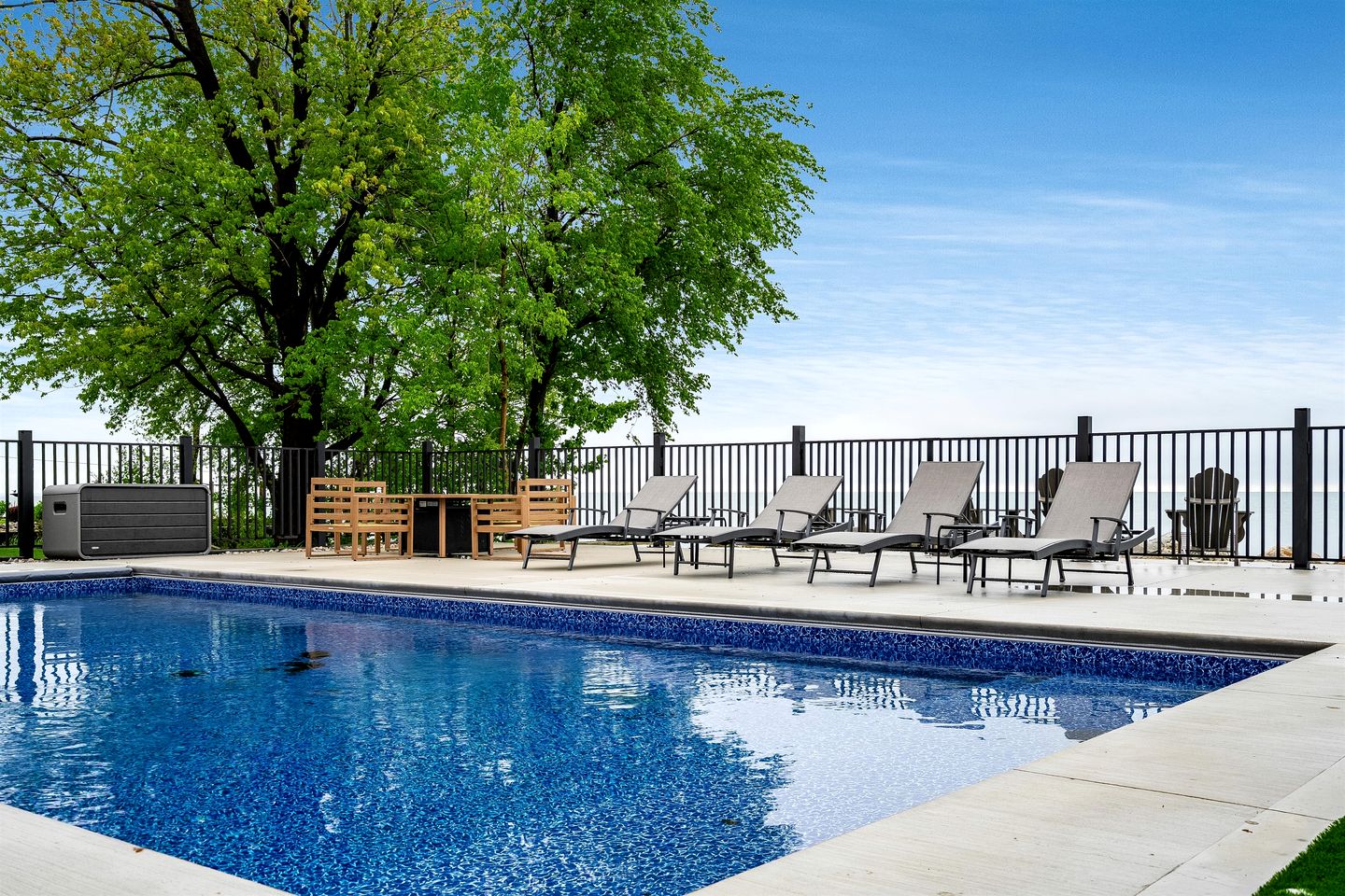 Sophisticated Shoreline Retreat with Sunset Patio & Poolside Lounging in Ontario, Canada