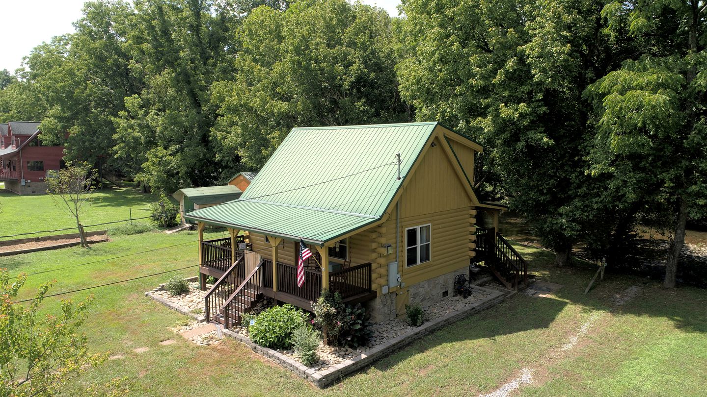 Elevate Your Tennessee Glamping Escape in this Lovely Riverside Cabin Rental in Newport